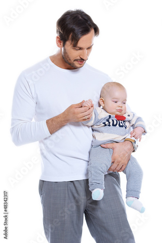 Photo: Loving father holding his small baby Loving father holding his small baby