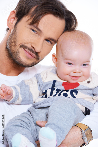 Photo: Closeup portait of a father and baby Closeup portait of a father and baby