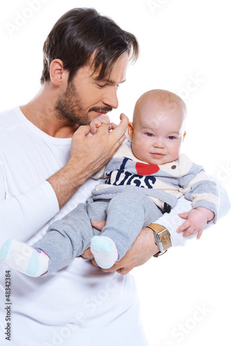 Photo: Young father cradling his baby on his arm Young father cradling his baby on his arm