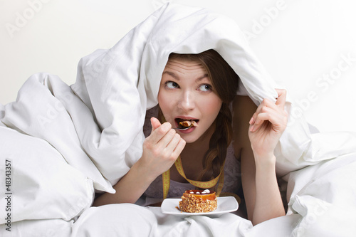 Photo: woman eating under cover woman eating under cover