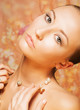 Tenderness. Portrait of Imposing Woman with Gold Pearly Chainlet