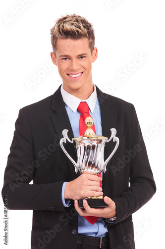 Photo: business man with win cup in hand business man with win cup in hand