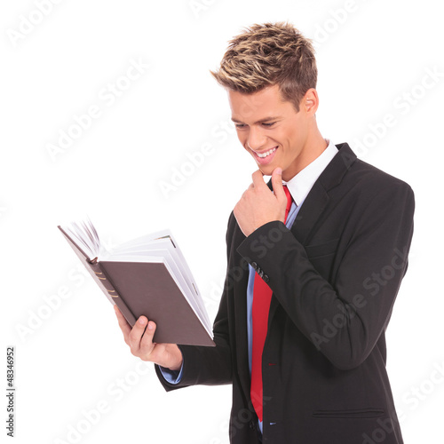 Photo: young student reading a law book young student reading a law book