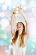 Photo: Young woman dancing with festive lights. Young woman dancing with festive lights.