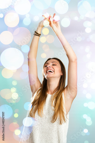 Photo: Young woman dancing with festive lights. Young woman dancing with festive lights.