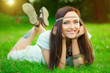 Photo: Smiling hippie girl on green grass Smiling hippie girl on green grass
