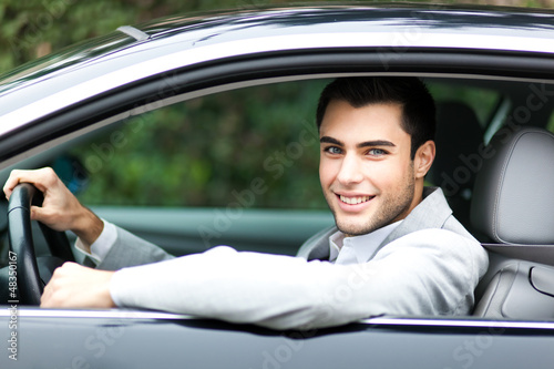 Photo: Handsome man driving his car Handsome man driving his car