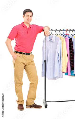 Photo: Full length portrait of a smiling guy posing on a hang rail full Full length portrait of a smiling guy posing on a hang rail full
