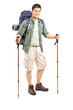 Full length portrait of a smiling hiker with backpack and hiking