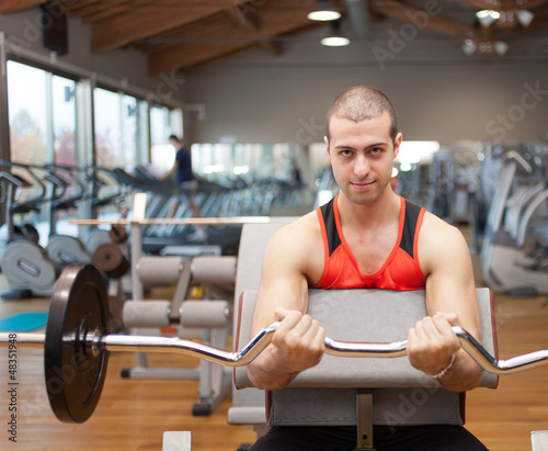 Photo: Man working out in a fitness club Man working out in a fitness club