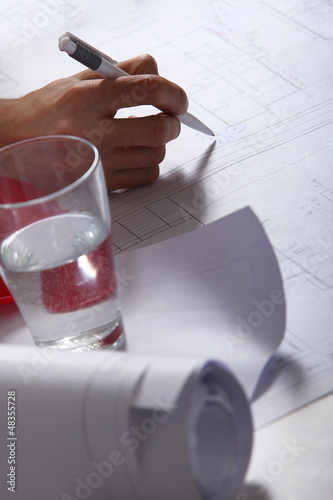 Photo: Hand on architecture plans Hand on architecture plans