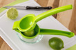 Cut limes with a juicer and knife on cutting board