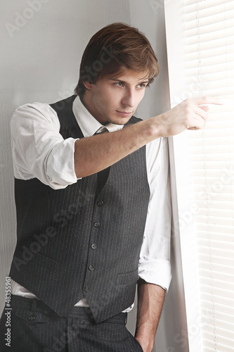Photo: Young businessman near the window Young businessman near the window