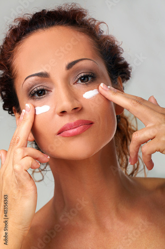Photo: Natural middle aged woman with cream Natural middle aged woman with cream