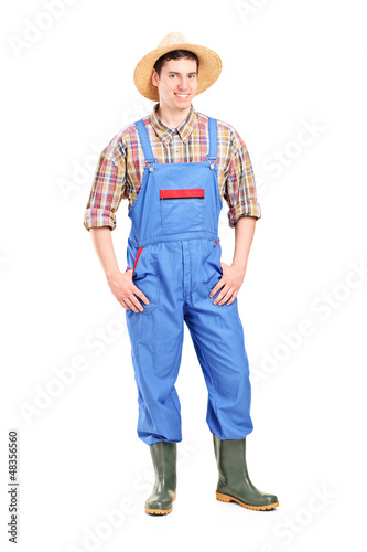 Photo: Full length portrait of a young male farmer smiling Full length portrait of a young male farmer smiling