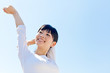 a young asian woman relaxing in the blue sky