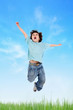 Photo: Adorable child jumping on the meadow Adorable child jumping on the meadow