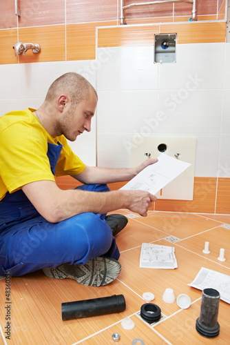 Photo: young plumber at work young plumber at work