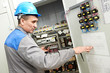 Electrician working at power line box