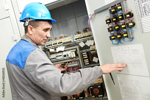 Photo: Electrician working at power line box Electrician working at power line box
