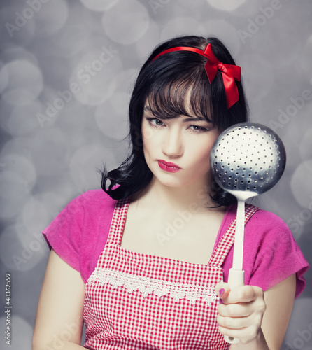Photo: Brunette housewife with soup ladle Brunette housewife with soup ladle