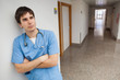 Nurse is leaning on the wall on the corridor and thinking