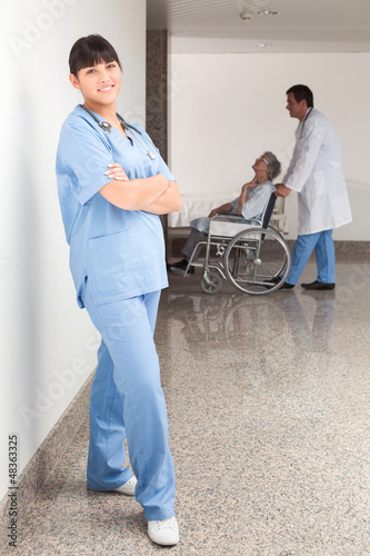 Photo: Proud nurse standing in the hallway Proud nurse standing in the hallway