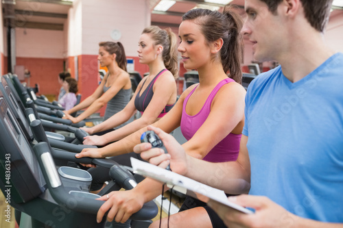 Photo: Instructor with stopwatch in gym Instructor with stopwatch in gym