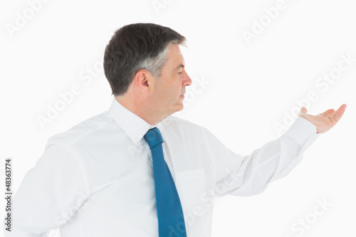Photo: Businessman holding out hand to the right Businessman holding out hand to the right