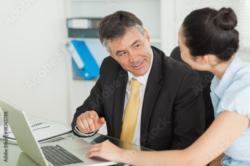 Photo: Business man and woman working together Business man and woman working together