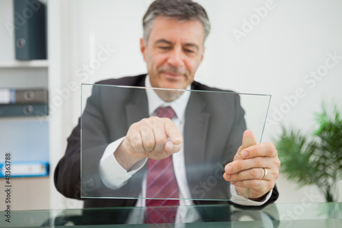 Photo: Happy man pointing on his virtual screen Happy man pointing on his virtual screen