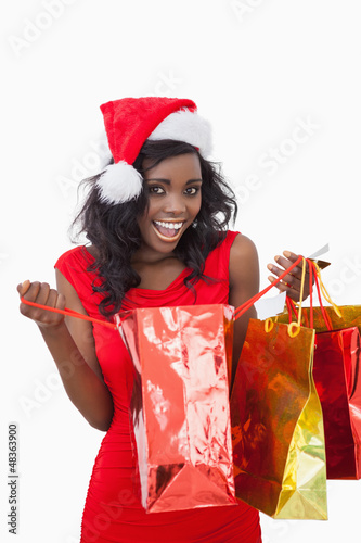 Photo: Woman holding bags while smiling Woman holding bags while smiling
