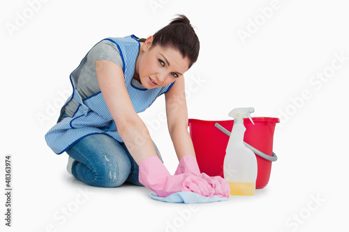 Photo: Exhausted cleaning woman wiping up the floor Exhausted cleaning woman wiping up the floor