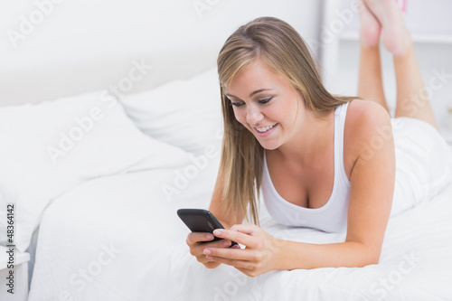 Photo: Cheerful woman using her phone Cheerful woman using her phone