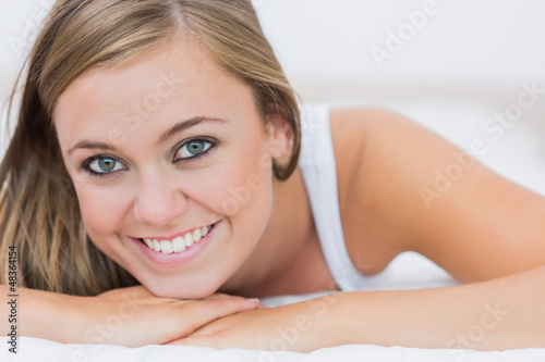 Photo: Blond woman lying on her bed Blond woman lying on her bed