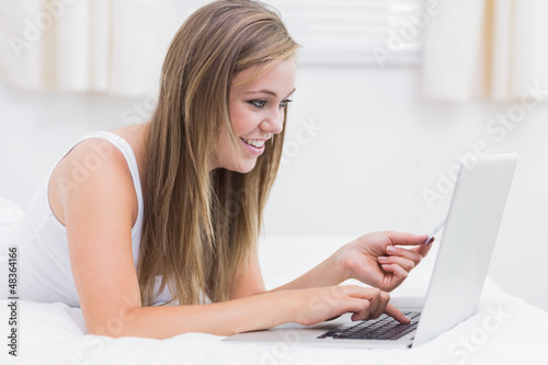 Photo: Cute woman buying on website Cute woman buying on website