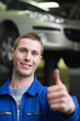 Handsome car mechanic gesturing thumbs up