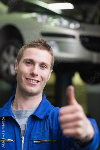 Photo: Handsome car mechanic gesturing thumbs up Handsome car mechanic gesturing thumbs up