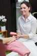 Portrait of female buffering toe nails at spa center
