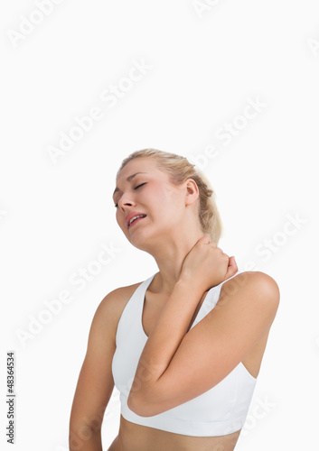 Photo: Young woman with severe neck pain Young woman with severe neck pain