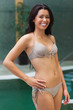 Photo: Happy girl standing by the pool Happy girl standing by the pool