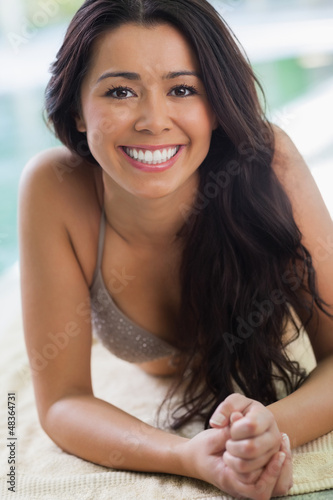 Photo: Happy girl lying by the pool Happy girl lying by the pool