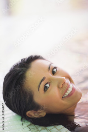 Photo: Pretty smiling woman lying in a jacuzzi Pretty smiling woman lying in a jacuzzi