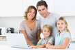 Smiling family with laptop