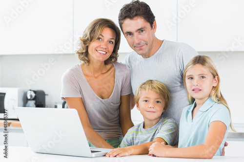 Photo: Smiling family with laptop Smiling family with laptop