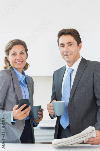 Photo: Business couple having coffee before work Business couple having coffee before work