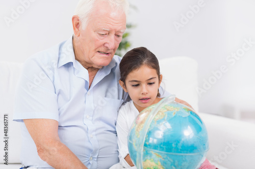 Photo: Granddaughter and grandfather with globe Granddaughter and grandfather with globe