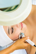 Asian woman getting a facial treatment in spa