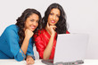 Cute smiling female students on laptop