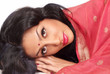Beautiful Indian woman in sari resting head on hands